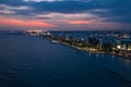 Aerial night panorama of Limassol, Cyprus waterfront. Famous mediterranean city resort in evening with Molos Park