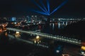 Aerial night shot of Bratislava city, bridges over the Danube river, and the vibrant nightlife lights in the city center