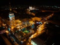 Aerial night shot of city during Christmas, winter and christmas decorations on square. Chistmas market during holiday Royalty Free Stock Photo