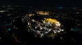 Aerial night video of iconic ancient Acropolis hill and the Parthenon at night, Athens historic center