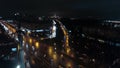 An aerial night view of a busy road against the endless urbanscape