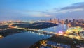 Aerial night view of colorful and vibrant cityscape of downtown in Ho Chi Minh City with Thu Thiem bridge