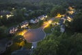 Aerial night view cul-de-sac road and spacious illuminated family houses in upstate New York suburban area. Real estate