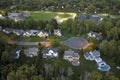 Aerial night view cul-de-sac road and spacious illuminated family houses in upstate New York suburban area. Real estate