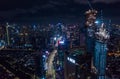 Aerial night view of high rise skyscrapers under construction and modern city center with multi lane highway in Jakarta Royalty Free Stock Photo