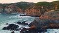 Aerial ocean breaking cliffs morning. Water crashing rugged stones sea foaming Royalty Free Stock Photo