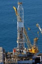 Aerial of an Offshore platform with drilling rig and crane.