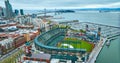 Aerial Oracle Park Mission Bay side with Oakland Bay Bridge and downtown skyscrapers