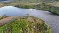 Aerial orbit shot of the island at Llyn Dywarchen in the Eryri National Park, Wales