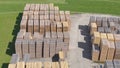 AERIAL: Organized stacks of spruce planks piling up in a lumberyard in Austria.