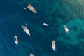 Aerial overhead drone shot of boats in Adriatic sea by Komiza town of Vis Island in Croatia before sunrise