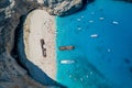 Aerial overhead drone shot of Zakynthos Navagio beach with tourists ,cruise ship and yachts