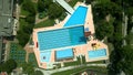 Aerial overhead shot of an empty generic outdoor swimming pool and small water park