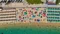 Aerial overhead view of lined beach umbrellas on a tropical beach