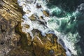Aerial, overhead view of waves and a rocky shoreline Royalty Free Stock Photo