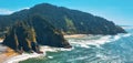 Aerial of Pacific Ocean in Oregon, Highway 101 winding through mountains.