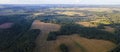 Aerial panorama of autumn farmlands with small village. Beautiful rural landscape with harvested from the field Royalty Free Stock Photo