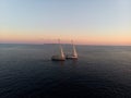Aerial panorama of boat sailboat ship sailing into sunset mediterranean sea ocean water Mallorca Balearic Islands Spain Royalty Free Stock Photo