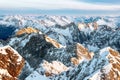 Brown and white snowy mountain tops in sunset