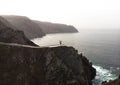 Aerial panorama of Cabo Ortegal lighthouse on steep rocky cliff atlantic ocean bay of biscay Carino Cape Galicia Spain