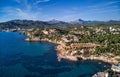 Aerial panorama of Costa de la Calma shoreline and turquoise clear green water of Mediterranean Sea. Hillside villas between pine