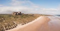 Aerial panorama landscape of Bamburgh Castle and sand dunes with beach in Northumberland Royalty Free Stock Photo