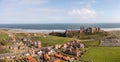 Aerial panorama landscape of Bamburgh Castle and village in Northumberland Royalty Free Stock Photo