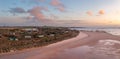 Aerial view of remote beach huts on the Northumberland coast at Embleton Bay