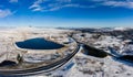 Aerial panorama of a major road running through a snow covered landscape Royalty Free Stock Photo