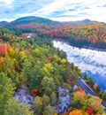 Aerial panorama over stunning peak fall mountains around blue lake with clean road and cliffs