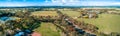 Aerial panorama of road, meadows and pastures.