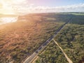 Aerial panorama of rural road passing through beautiful Australian countryside at sunset. Royalty Free Stock Photo