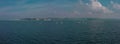 Aerial panorama of sailboats on a competition in Optimist class on open waters on the sea during sunny weather