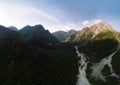 Aerial panorama of the stormy flow of the Dolra River, in the middle of a forest and high Caucasian mountains, a hiking trail, a Royalty Free Stock Photo