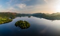 Aerial panorama of sunset next to a beautiful, flat calm lake