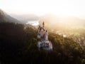 Aerial panorama sunset view of bavarian alpine mountain landscape with Neuschwanstein fairytale castle Fuessen Germany