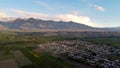Aerial panorama of the town of Kochkor, Kyrgyzstan and surrounding fields and mountains Royalty Free Stock Photo