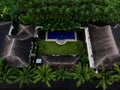 Aerial panorama of tropical island hotel resort blue swimming pool green jungle palm trees in Seminyak Bali Indonesia Royalty Free Stock Photo