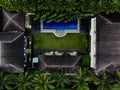 Aerial panorama of tropical island hotel resort blue swimming pool green jungle palm trees in Seminyak Bali Indonesia Royalty Free Stock Photo