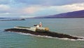Aerial panorama view of the historic Fenit Lighthouse in Tralee Bay, beautiful clouds, sunset