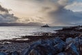 Aerial panorama view of the historic Fenit Lighthouse in Tralee Bay, beautiful clouds, sunset