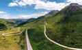 Aerial panorama view of the road for travelers on a motorcycle, car, incredible beauty views of green meadows and majestic