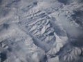 Aerial panorama view of snow covered mountain range peaks winter landscape seen from airplane window over Turkey Asia Royalty Free Stock Photo