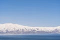 Aerial panorama view snow covered mountains. Snowy mountain ridge on winter sunrise. Stunning mountains range covered with snow Royalty Free Stock Photo