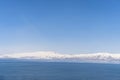 Aerial panorama view snow covered mountains. Snowy mountain ridge on winter sunrise. Stunning mountains range covered with snow Royalty Free Stock Photo