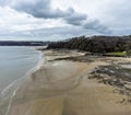 An aerial panorama view west along the beach at Wisemans Bridge in Pembrokeshire, South Wales