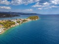 Aerial panoramic photo of picturesque seaside town of Ermioni built in peninsula with forest of Bistis at the end, Argolida, Royalty Free Stock Photo