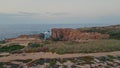 Aerial panoramic rocky cape on dawn. Drone flying over beautiful ocean cliffs Royalty Free Stock Photo