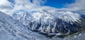 Aerial panoramic view above the Pirin mountains with rocky peaks covered with snow. Winter view at Bansko ski resort in Bulgaria Royalty Free Stock Photo