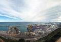 Aerial panoramic view of barcelona docks and harbour with shipping containers being loaded, warehouses grain silos and railway